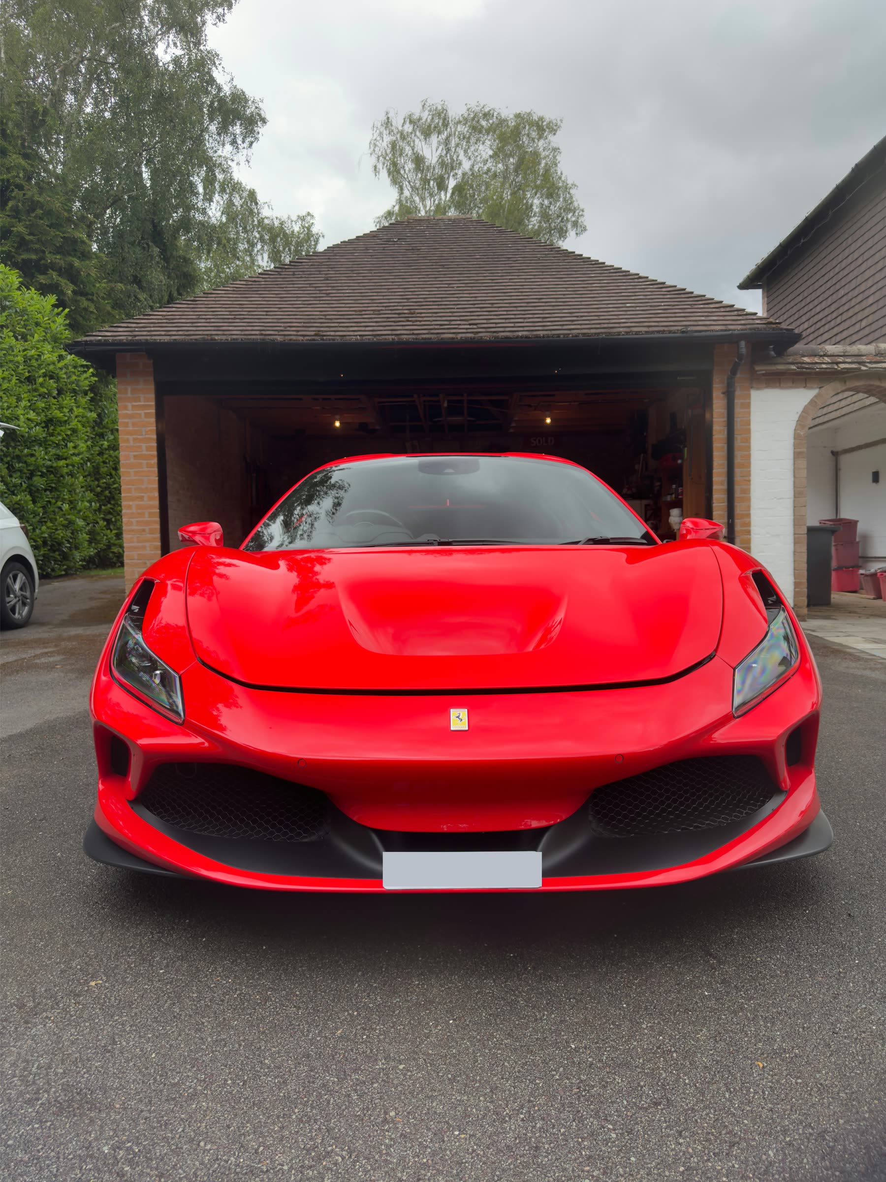 Front view of a finished red Ferrari with the registration obscured