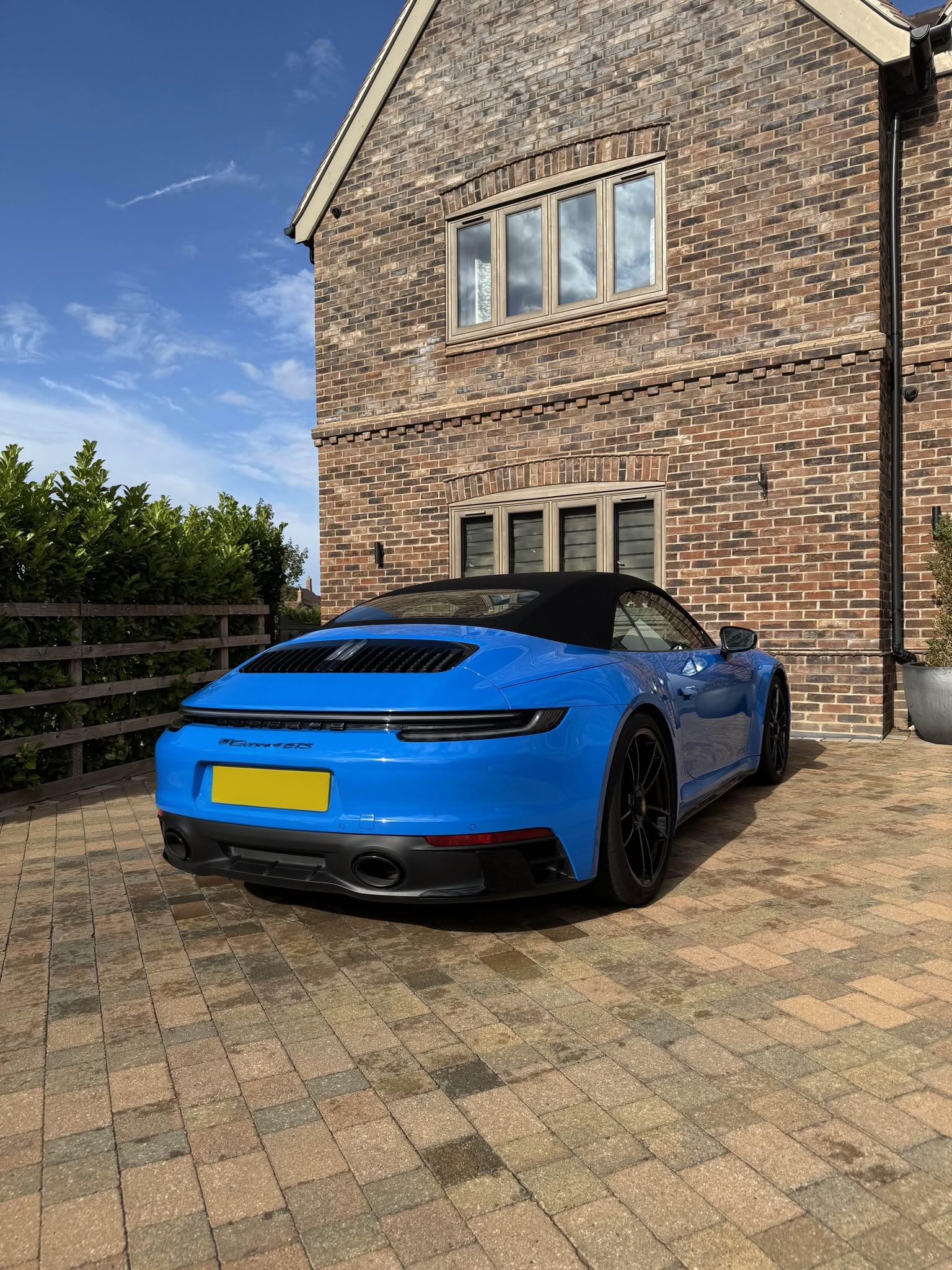 Rear view of a finished blue Porsche with its registration obscured